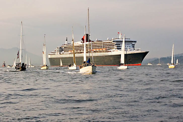 Spectator Sailboats Suround the Queen Mary 2
